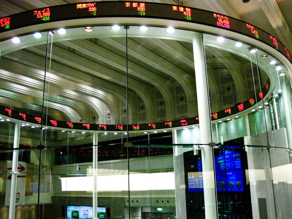 Trading screens at a stock exchange, representing market reaction to disclosure